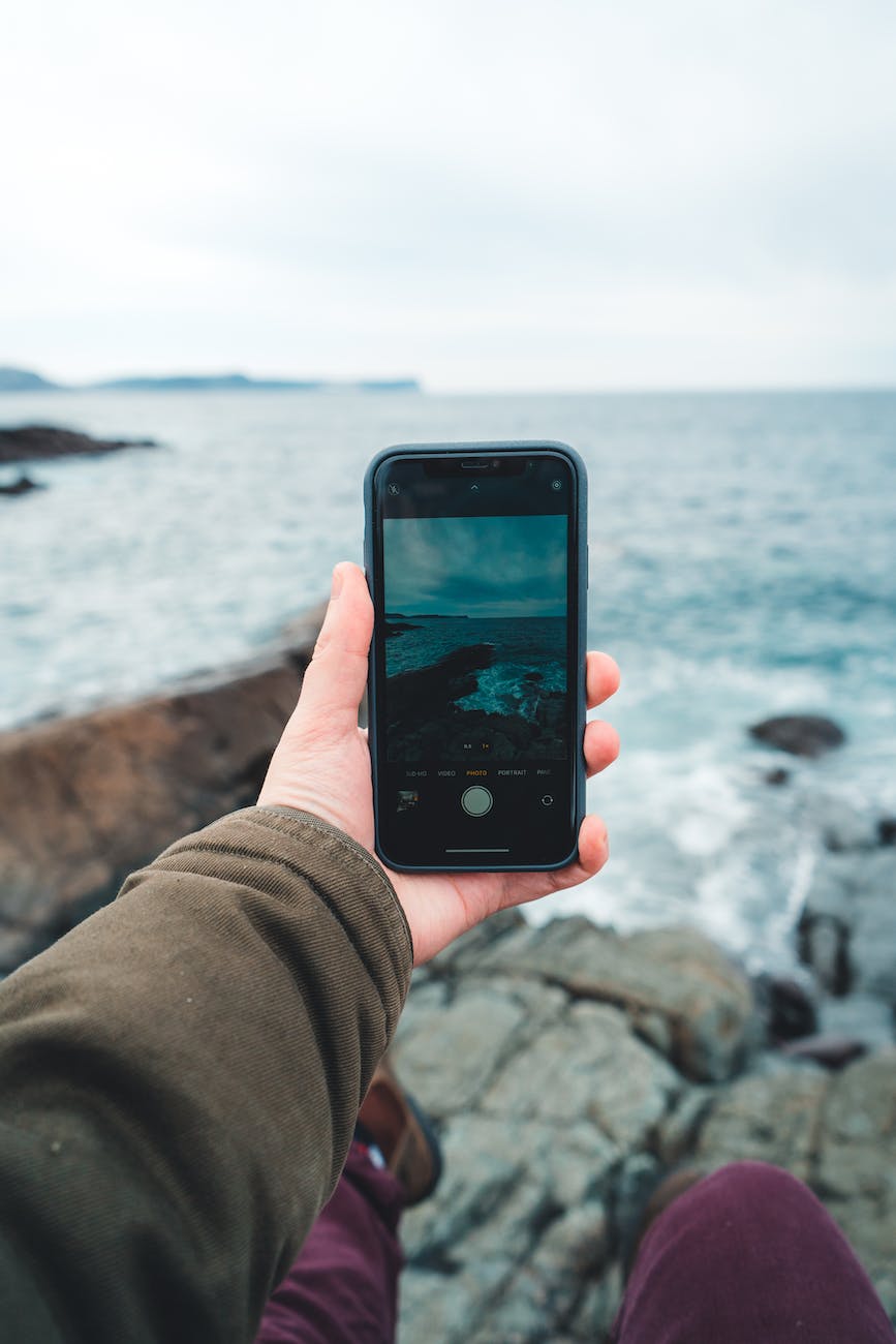 person taking photo with mobile phone camera